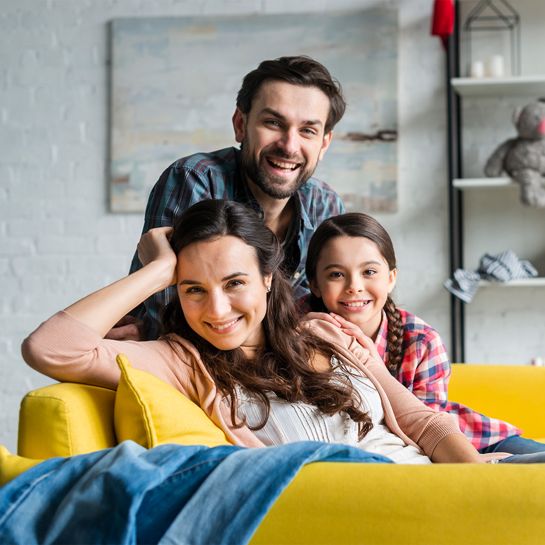 happy-family-sitting-couch-living-room